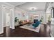 Elegant living room featuring hardwood floors, comfortable seating, and access to the backyard at 1427 Bungalow Ave, Durham, NC 27703