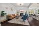 Open-concept living room with hardwood floors, comfortable seating, and stylish decor at 1427 Bungalow Ave, Durham, NC 27703