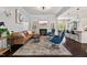 Elegant living room featuring a leather sectional, stylish decor, fireplace and an open floor plan at 1427 Bungalow Ave, Durham, NC 27703