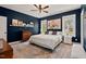 Spacious main bedroom with plush rug, dark accent wall, and natural light at 1427 Bungalow Ave, Durham, NC 27703