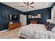 Serene main bedroom with a dark accent wall, neutral rug, and natural light at 1427 Bungalow Ave, Durham, NC 27703