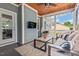 Relaxing screened porch featuring a ceiling fan, egg chair, TV, and neutral colored sofa and chairs at 1427 Bungalow Ave, Durham, NC 27703
