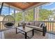 Comfortable screened porch with wood ceiling, furniture, egg chair, and views of the private backyard at 1427 Bungalow Ave, Durham, NC 27703
