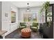 Inviting sitting room filled with natural light, plush chairs, and playful outdoor views at 1427 Bungalow Ave, Durham, NC 27703