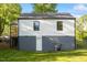 White siding on a home's exterior with a basement entrance and a well-manicured lawn at 1513 Fairfax Rd, Durham, NC 27701