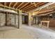 Unfinished basement with concrete flooring and exposed ceiling at 1513 Fairfax Rd, Durham, NC 27701