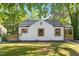 Charming home featuring a new roof and stylish wooden shutters, complemented by a lush green lawn at 1513 Fairfax Rd, Durham, NC 27701