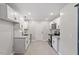Efficient kitchen featuring sleek white cabinets, granite countertops, stainless appliances, and tiled floors at 1513 Fairfax Rd, Durham, NC 27701