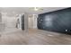 Open-concept living space with modern flooring, accent wall, and seamless flow to the adjacent kitchen at 1513 Fairfax Rd, Durham, NC 27701