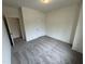 This is a spacious bedroom with neutral carpeting and a bright overhead light at 152 Bruce Dr, Dunn, NC 28334