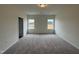 Bright bedroom featuring neutral carpet, two windows and natural light at 152 Bruce Dr, Dunn, NC 28334