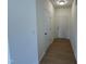 Bright entryway with wood-look floors, white walls, and a front door at 152 Bruce Dr, Dunn, NC 28334