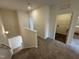 Upstairs hallway with carpet, and views of the laundry and stairwell at 152 Bruce Dr, Dunn, NC 28334