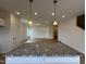 Kitchen island with granite countertop and view of the living space and stairs at 152 Bruce Dr, Dunn, NC 28334