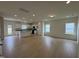 Open living room with wood floors, white walls, recessed lights and views into the kitchen at 152 Bruce Dr, Dunn, NC 28334
