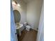 Half bathroom featuring a pedestal sink, toilet, and wood-look floors at 152 Bruce Dr, Dunn, NC 28334