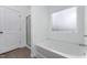 Bathroom featuring a tub with tiled surround, glass shower door, and linen closet at 152 Bruce Drive Dr, Dunn, NC 28334