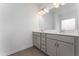 This bathroom boasts a double sink vanity and large mirror with decorative lighting at 152 Bruce Drive Dr, Dunn, NC 28334