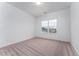 This light-filled bedroom has neutral carpet and a double-hung window at 152 Bruce Drive Dr, Dunn, NC 28334