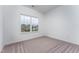 This bedroom boasts a view of the neighborhood with carpet and white walls at 152 Bruce Drive Dr, Dunn, NC 28334