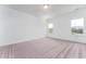 This primary bedroom with carpet features a double window and neutral walls at 152 Bruce Drive Dr, Dunn, NC 28334