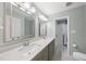 Bathroom with double sinks, large mirrors, and gray cabinets at 1532 Cone Ave, Apex, NC 27502