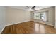 This bedroom features hardwood floors, a large window that provides natural light, and a neutral color scheme at 1532 Cone Ave, Apex, NC 27502