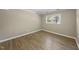 Bedroom features light walls, wood look flooring, and a bright window at 1532 Cone Ave, Apex, NC 27502