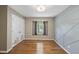 Neutral bedroom with a geometric accent wall, closet, and wood-look floors at 1532 Cone Ave, Apex, NC 27502