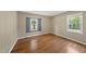 Bedroom with wood-look floors, and two bright, natural light-filled windows at 1532 Cone Ave, Apex, NC 27502