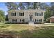 Charming home featuring a well-manicured lawn, updated exterior, black shutters, and a welcoming front entrance at 1532 Cone Ave, Apex, NC 27502