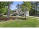 Beautiful home featuring a lush lawn, mature trees, updated exterior, and attached garage in quiet neighborhood at 1532 Cone Ave, Apex, NC 27502