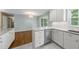 Eat-in kitchen showcases stainless steel appliances, granite countertops, white cabinetry, and access to outdoor space at 1532 Cone Ave, Apex, NC 27502