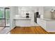 Bright, updated kitchen features stainless steel appliances, granite countertops, and white cabinetry at 1532 Cone Ave, Apex, NC 27502