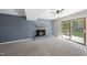 Cozy living room with a brick fireplace and sliding door access to the outside, great for indoor-outdoor living at 1532 Cone Ave, Apex, NC 27502