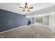 Spacious living room featuring gray brick wall, fireplace, and neutral carpet at 1532 Cone Ave, Apex, NC 27502