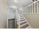A staircase with carpeted steps and white railings leads to the upper level, showcasing the home's interior design at 1532 Cone Ave, Apex, NC 27502