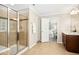 Open bathroom with tiled shower, glass door, and a wood cabinet at 1557 Tice Hurst Ln, Apex, NC 27502
