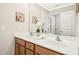 Bathroom featuring a double sink vanity, complemented by floral decor and ample lighting at 1557 Tice Hurst Ln, Apex, NC 27502