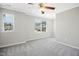 Bedroom features a ceiling fan, carpet, and large windows at 1557 Tice Hurst Ln, Apex, NC 27502