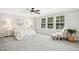 Bright bedroom with large windows, soft carpet, ceiling fan, and tray ceiling at 1557 Tice Hurst Ln, Apex, NC 27502