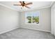 Bedroom featuring a ceiling fan, carpet, and large windows at 1557 Tice Hurst Ln, Apex, NC 27502