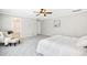 Bedroom features carpet, tray ceiling, ceiling fan, and a chair at 1557 Tice Hurst Ln, Apex, NC 27502