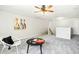 Relaxing bonus room featuring a ceiling fan, artwork, and a cozy corner setup at 1557 Tice Hurst Ln, Apex, NC 27502