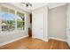 Bright dining room featuring hardwood floors and a large window for natural light at 1557 Tice Hurst Ln, Apex, NC 27502