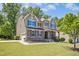 Attractive two-story home with a two car garage, landscaped lawn, and covered front porch with stone accents at 1557 Tice Hurst Ln, Apex, NC 27502