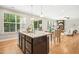 Bright kitchen with stainless steel appliances, granite countertops, and views to the living room and backyard at 1557 Tice Hurst Ln, Apex, NC 27502