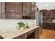 Kitchen features granite countertops, dark wood cabinets, stainless steel appliances, and butler's pantry at 1557 Tice Hurst Ln, Apex, NC 27502