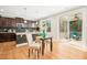 Eat-in kitchen features dark wood cabinets, granite countertops, stainless steel appliances, and access to the screened porch at 1557 Tice Hurst Ln, Apex, NC 27502