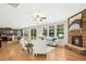 Open-concept living room features hardwood floors, a cozy fireplace, and seamless access to a modern kitchen and dining area at 1557 Tice Hurst Ln, Apex, NC 27502